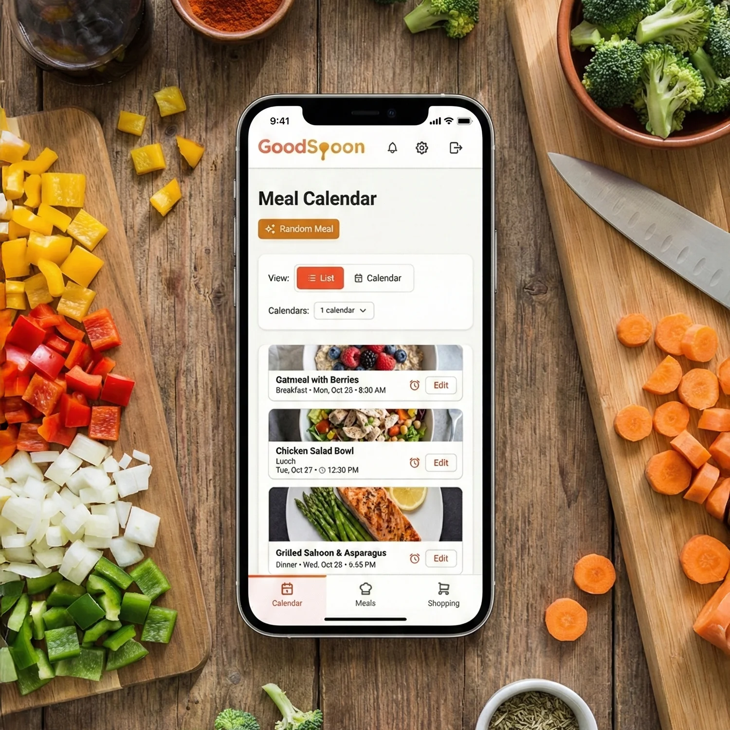 Smartphone displaying GoodSpoon meal planning app on kitchen countertop surrounded by fresh chopped vegetables and seasonings