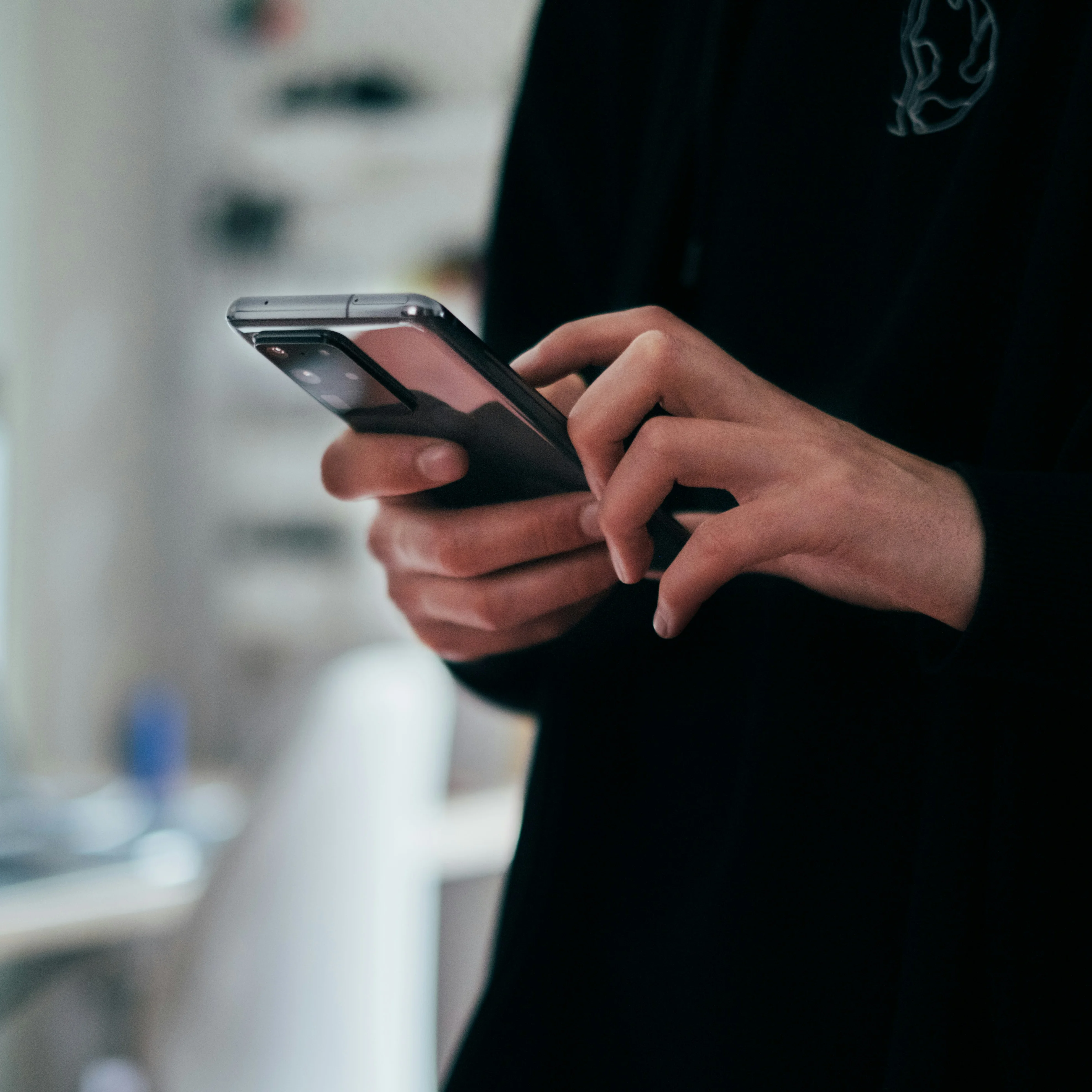 Person setting up GoodSpoon app preferences on their smartphone, configuring household size and dietary restrictions