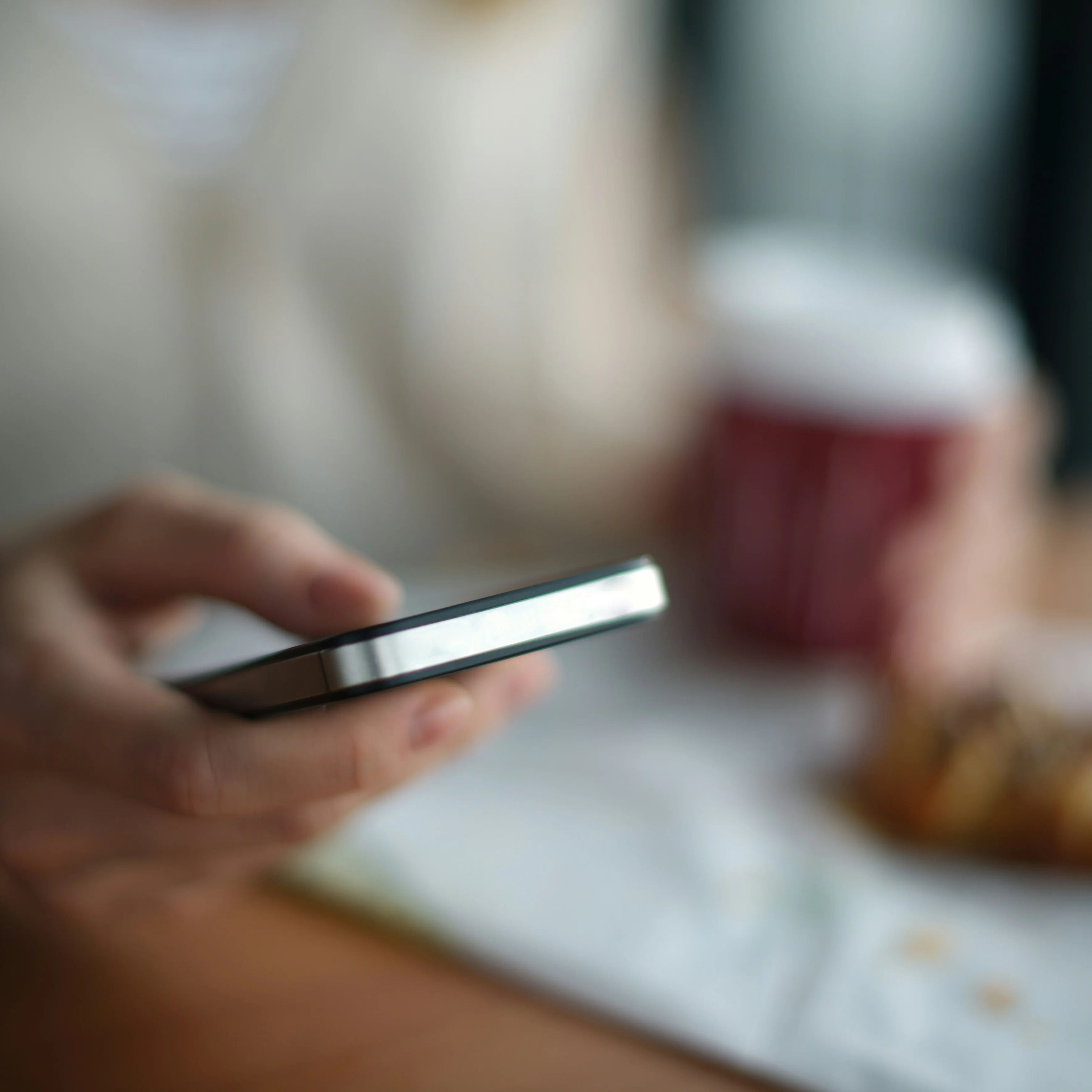Person viewing auto-generated shopping list on their smartphone with ingredients organized by category